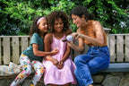 Woman giving two younger girls elderberry tonic