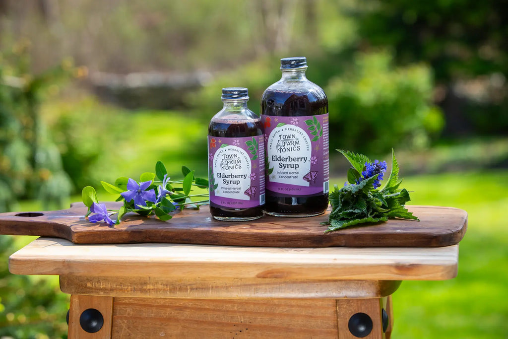 Elderberry tonics on wood cutting board outside