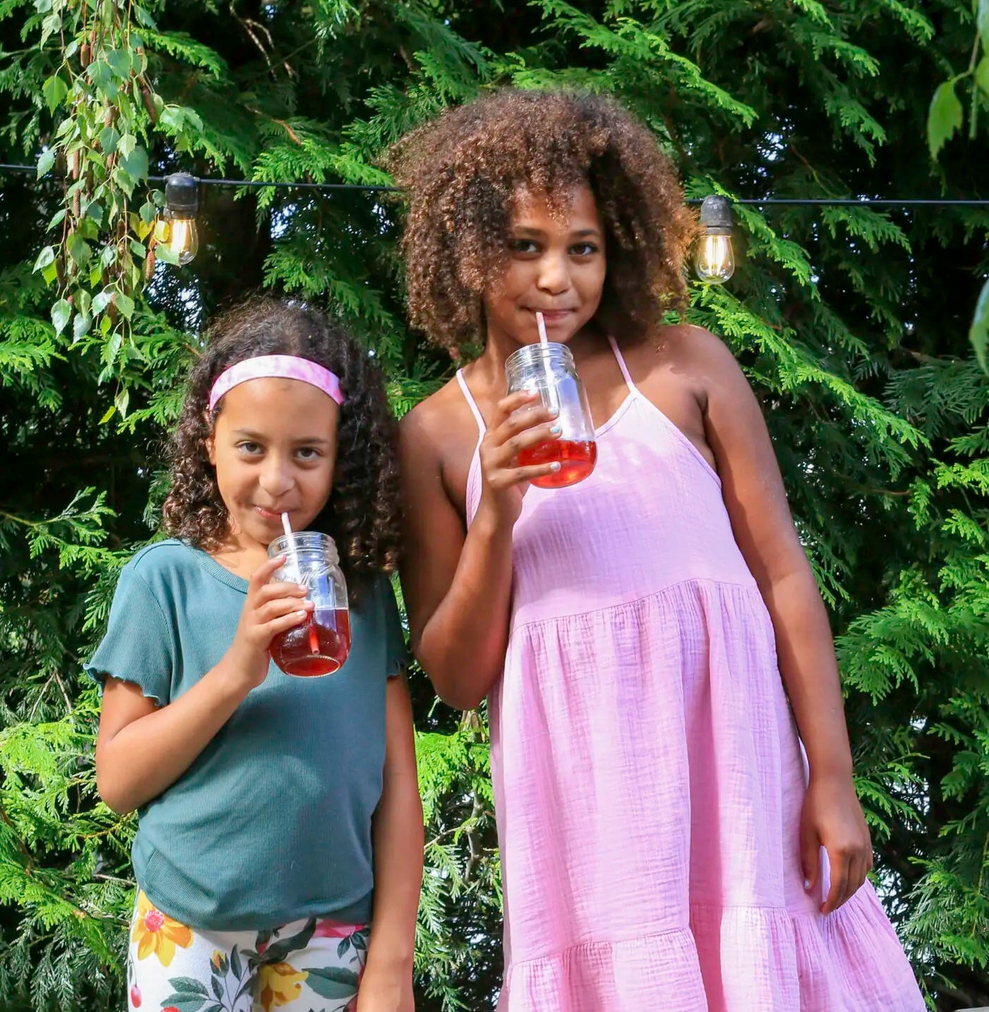 Two young girls drinking tonics