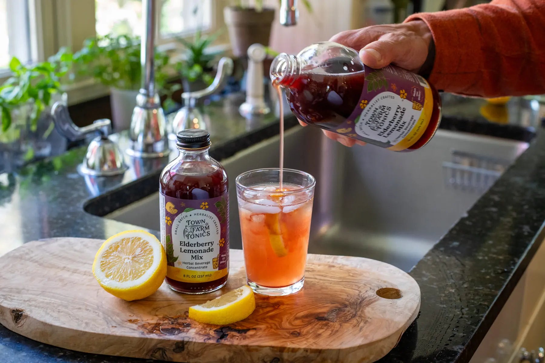 Lemon Rose Herbal Electrolyte Mix being poured into glass