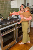 Woman holding baby making Fire Cider tonic