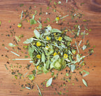 Snooze tea herbs laid out on wood table