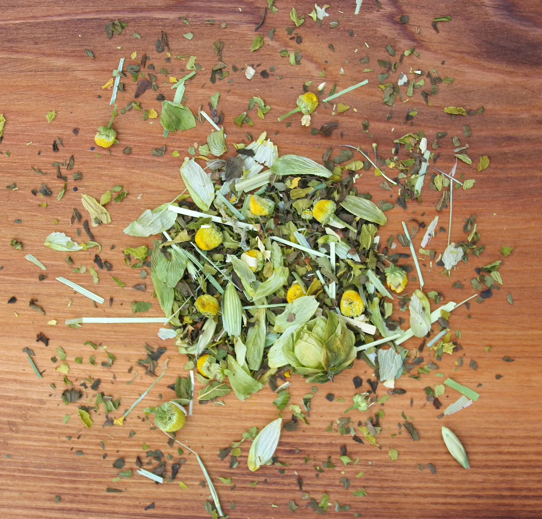 Snooze tea herbs laid out on wood table