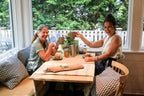 Two women sitting at a table drinking the tonics