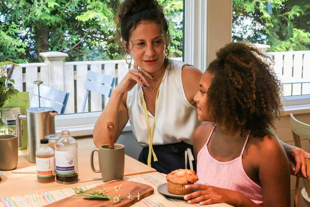 Women sitting at table drinking snooze product