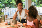 Women sitting at table drinking snooze product