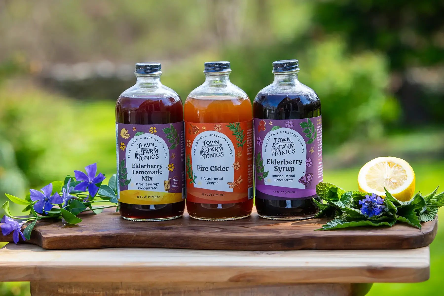Three bottles of Town Farm Fresh tonics on a wooden board with a natural background